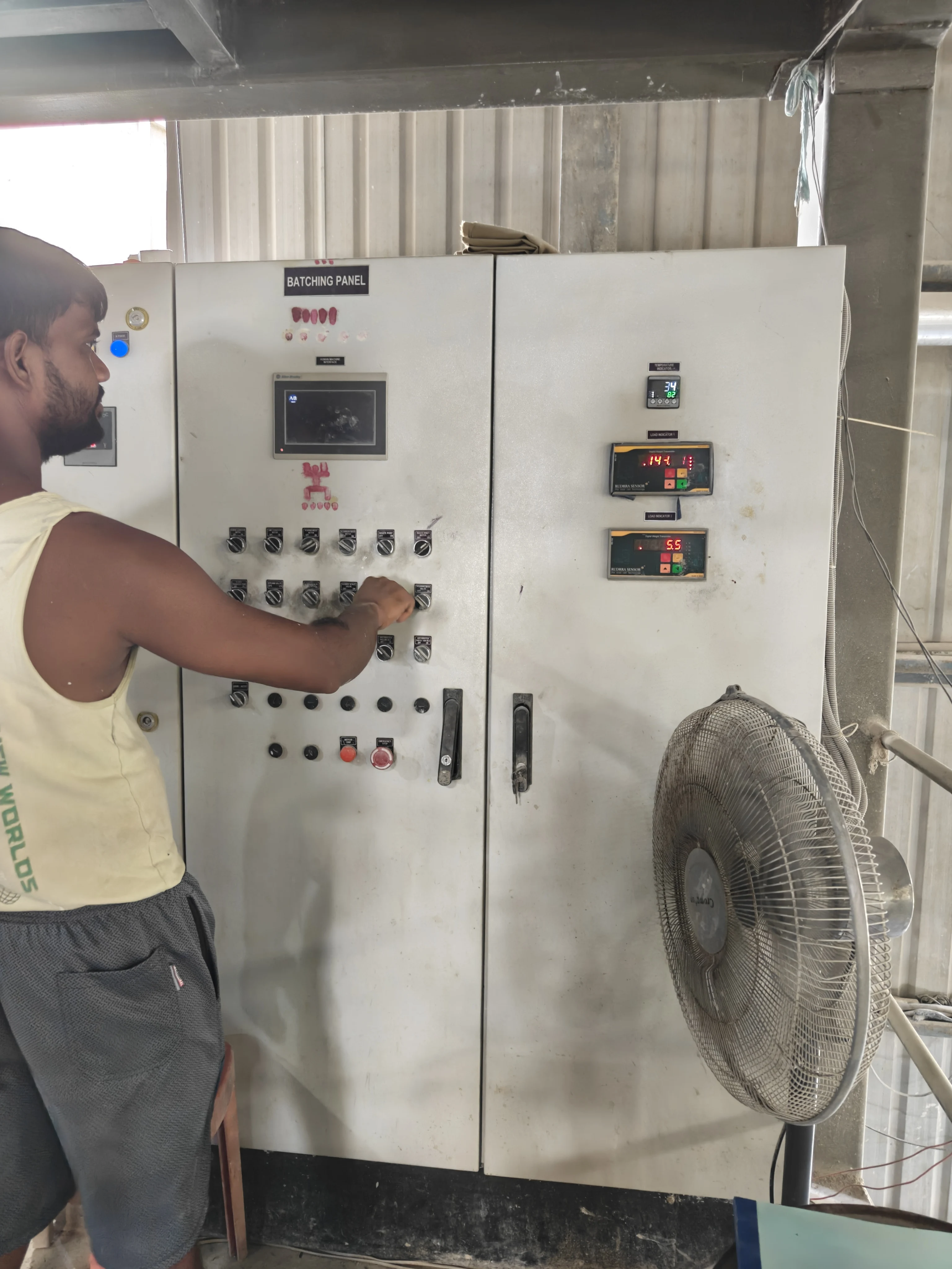Operator at the computerised batching panel of the mixing plant