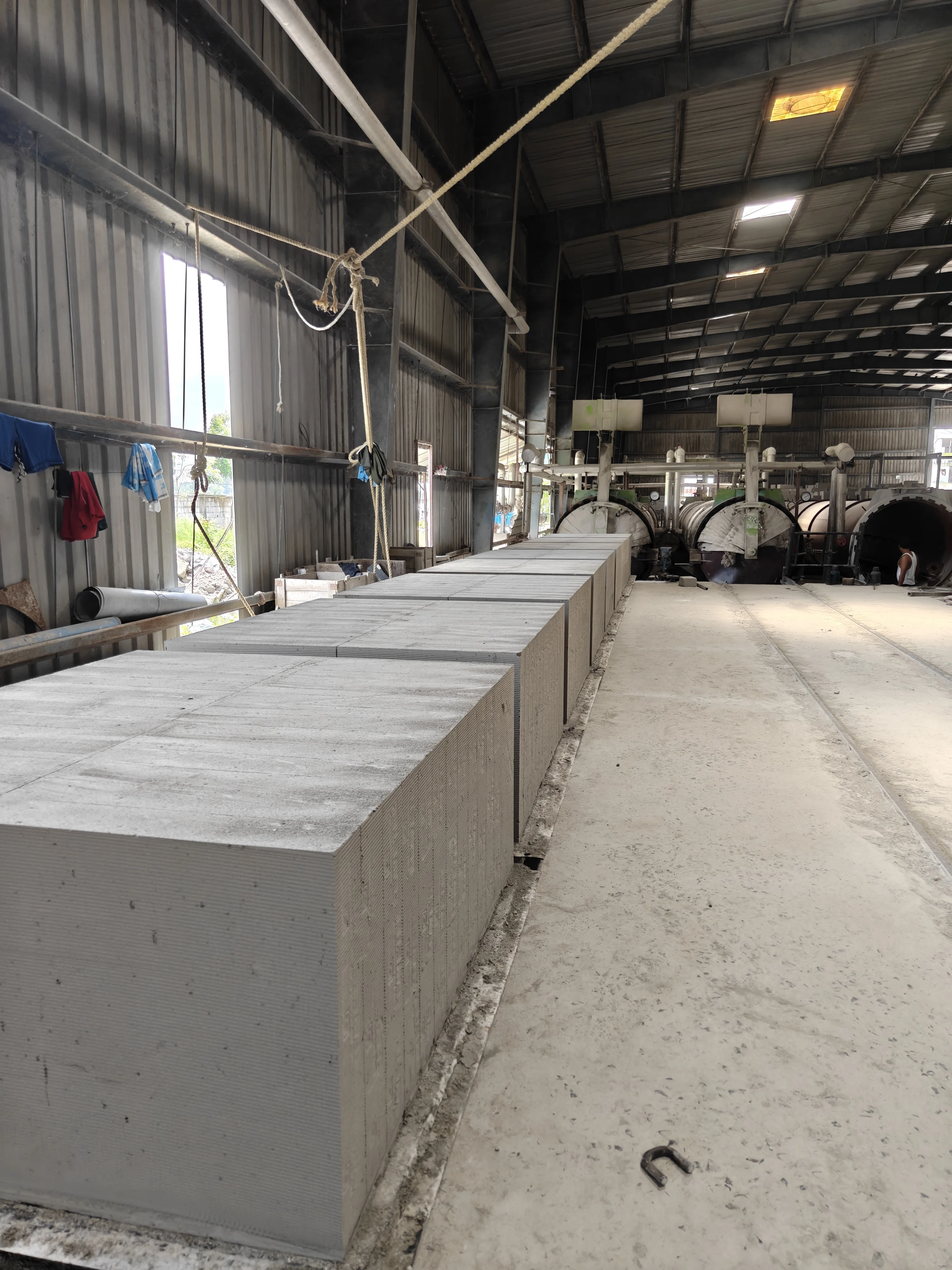 Green cakes lined up in front of the autoclaves